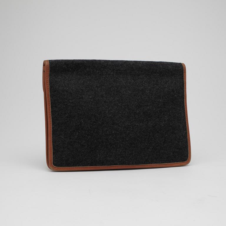 CÉLINE, a grey clutch bag.