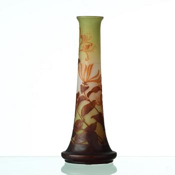 Emile Gallé, an Art Nouveau cameo vase with amber coloured honey suckle against yellow background, Nancy, France.