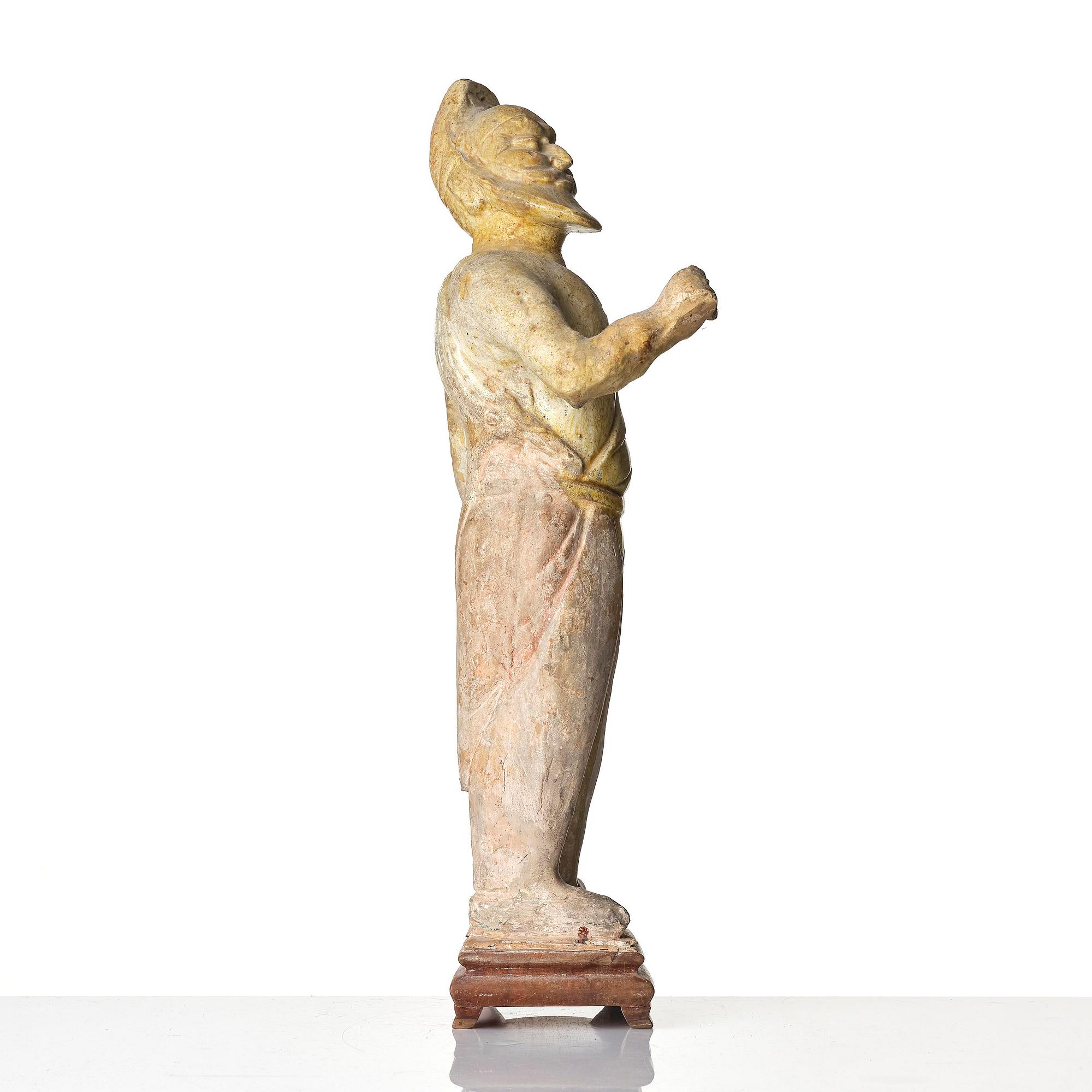 A yellow glazed potted figure of a groom, Tang dynasty (618-907).