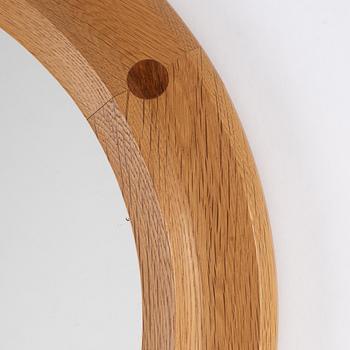 A round oak mirror by Åke Fribyter for Aktuell Form AB, second half of the 20th Century.