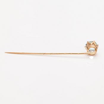 A 14K gold tiepin with a aquamarine.