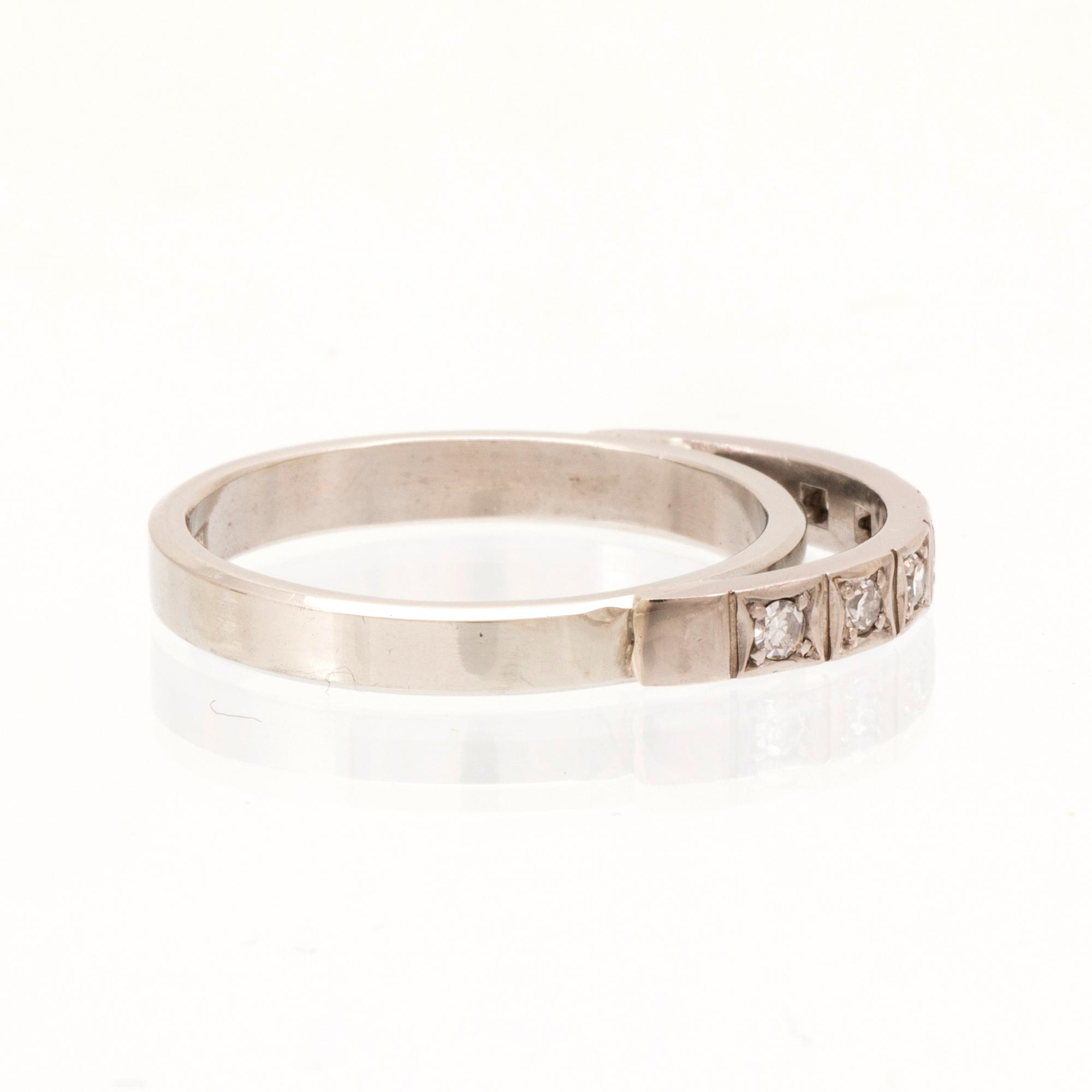 An 18K white gold ring set with round single cut dimamonds.