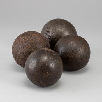 Four19th century iron bullets.