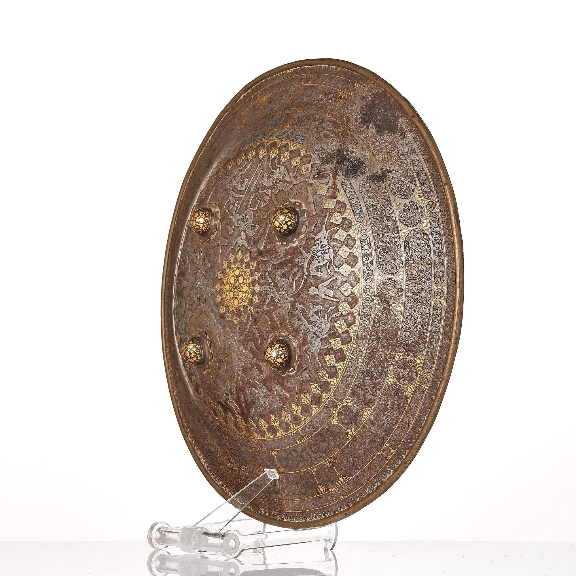 A gold-damascened steel shield, Qajar Iran, 19th century.