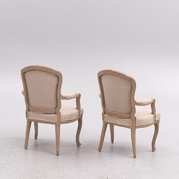 A painted pair of rococo armchairs, 19th century.