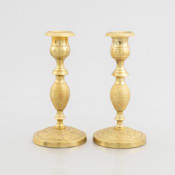 A pair of brass candlesticks, first half of the 19th Century.