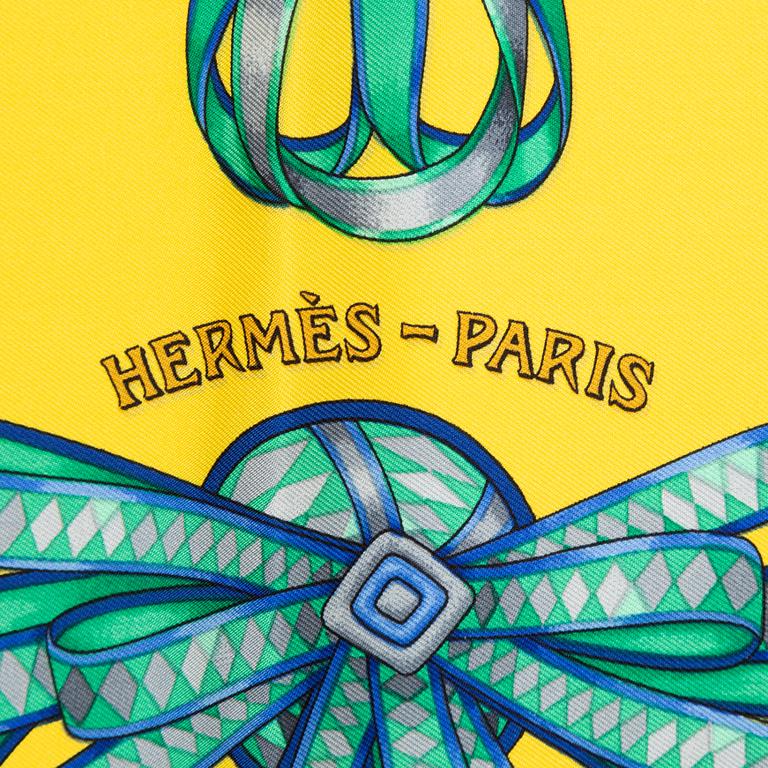 Hermès, a 'Les Rubans du Cheval' silk scarf.