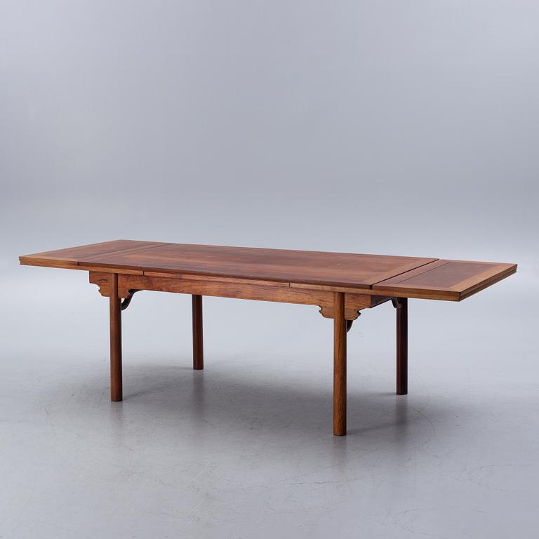 A Chinese hardwood dinner table and ten chairs with rattan seats, 20th century.