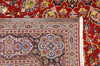 A Keshan carpet, part silk, signed, approx. 398 x 270 cm.