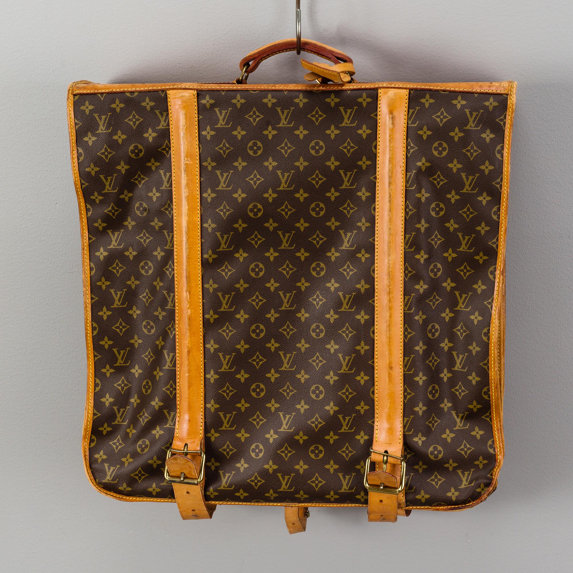 A Louis Vuitton vintage Monogram Canvas Homme Garment Bag.