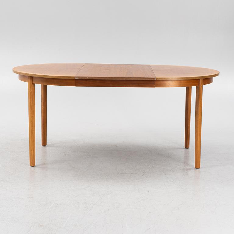 A teak veneered dining table, second part of the 20th Century.