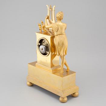 An Empire table clock, dial marked "L Ravrio Bronzier à Paris Mesnil H", fist half of the 20th century.