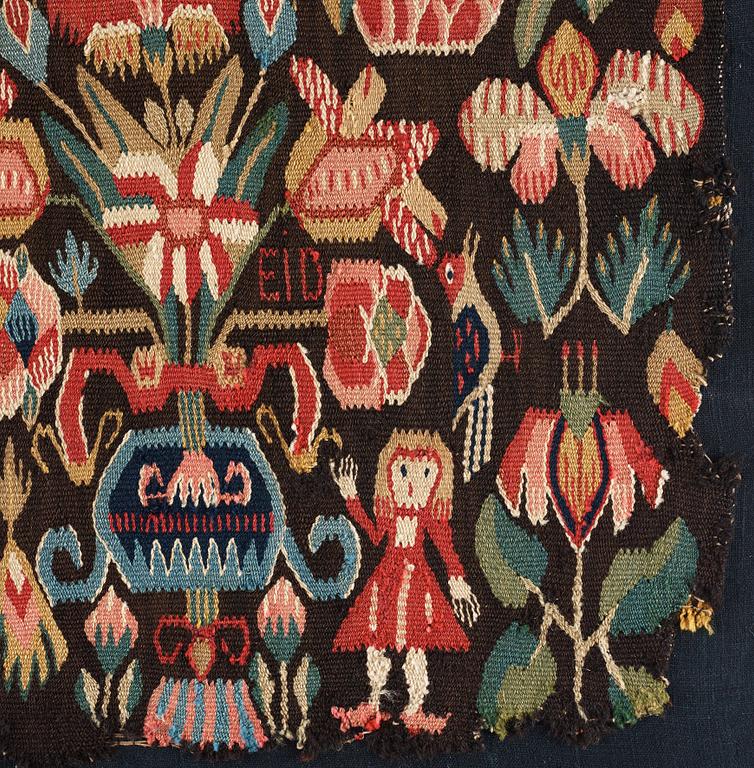 A CARRIAGE CUSHION FRAGMENT, tapestry weave, "Urnor och par", ca 51-53,5 x 92-97 cm, Scania (Sweden).