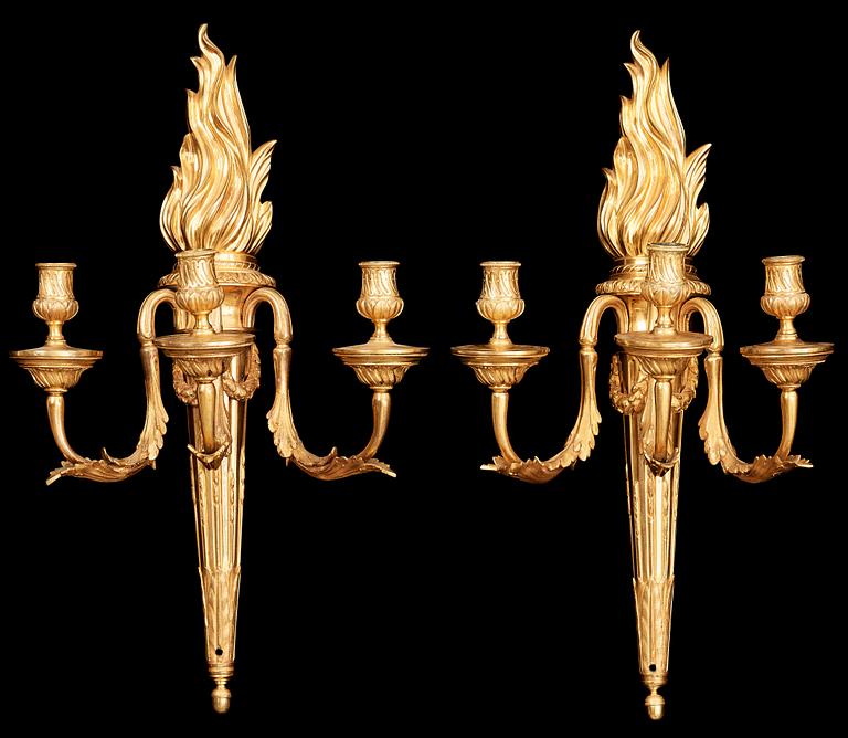 A pair of Louis XVI late 18th century gilt bronze three-light wall-lights.