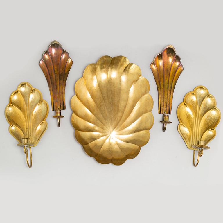 Four brass wall sconces  and one brass plate by Lars Homström, Arvika, second half of the 20th century.