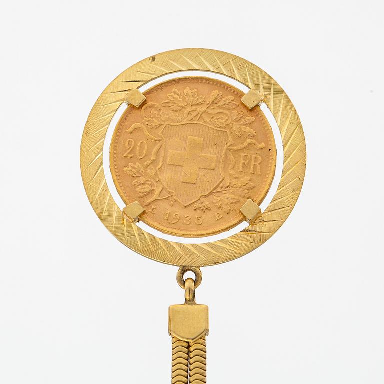 A keychain made of 18K gold with a 900 gold Helvetia 20 franc coin.