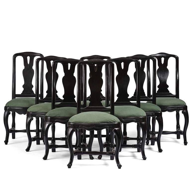 A set of eight black Swedish rococo chairs.