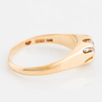 Ring, with faceted white stone.