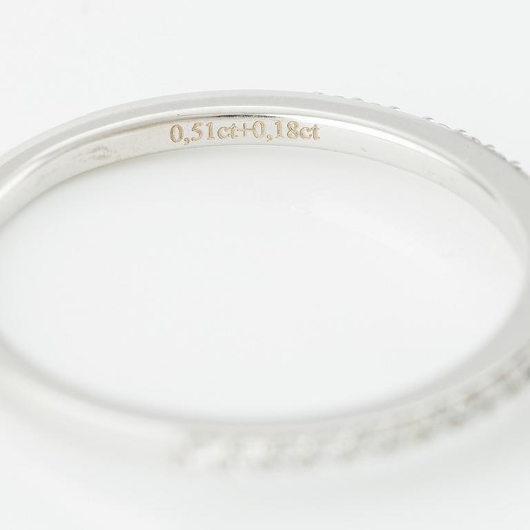 Ring with cushion-cut diamond.