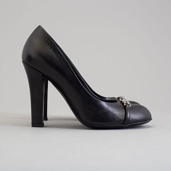 A pair of black pumps by Gucci.