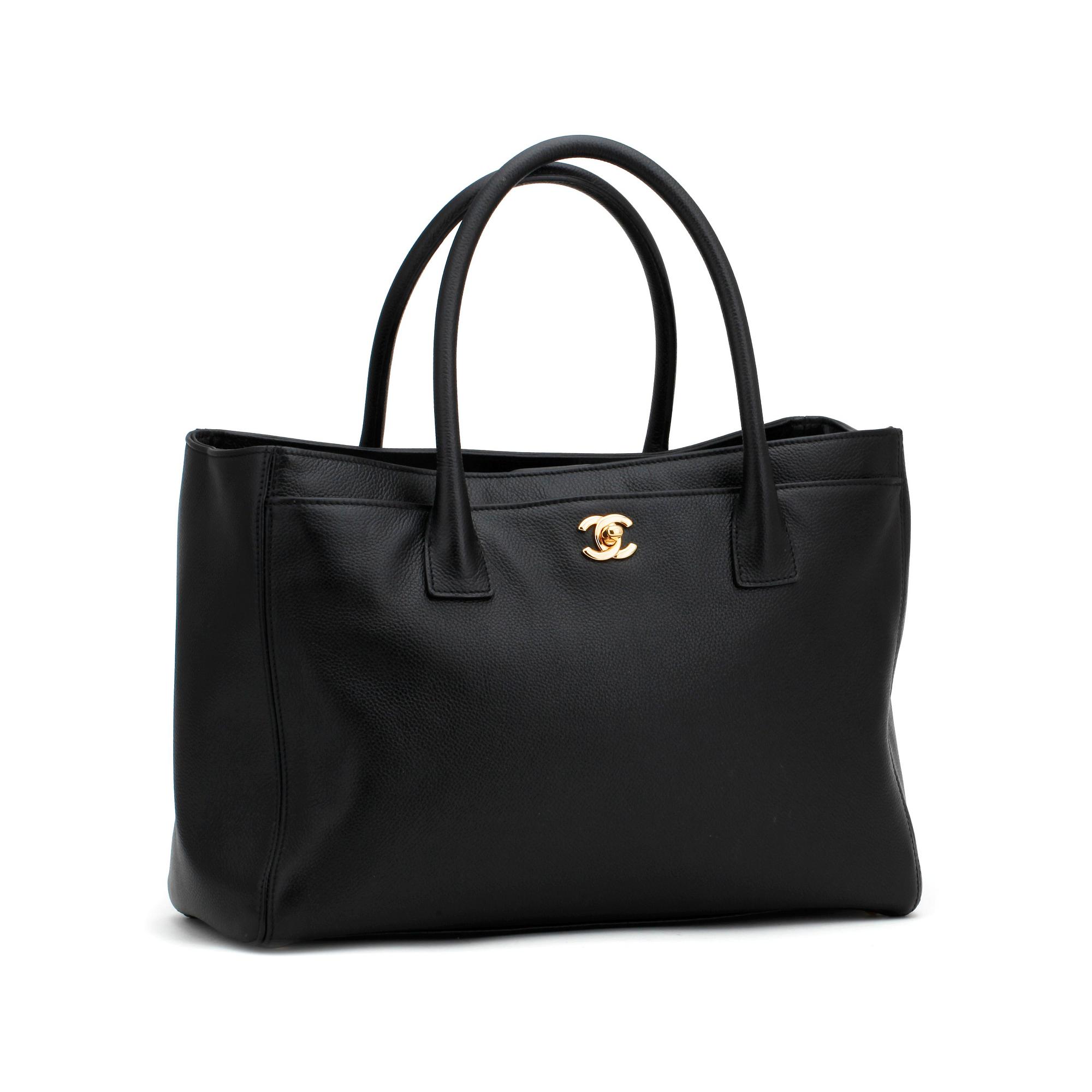CHANEL,  a black leather bag.
