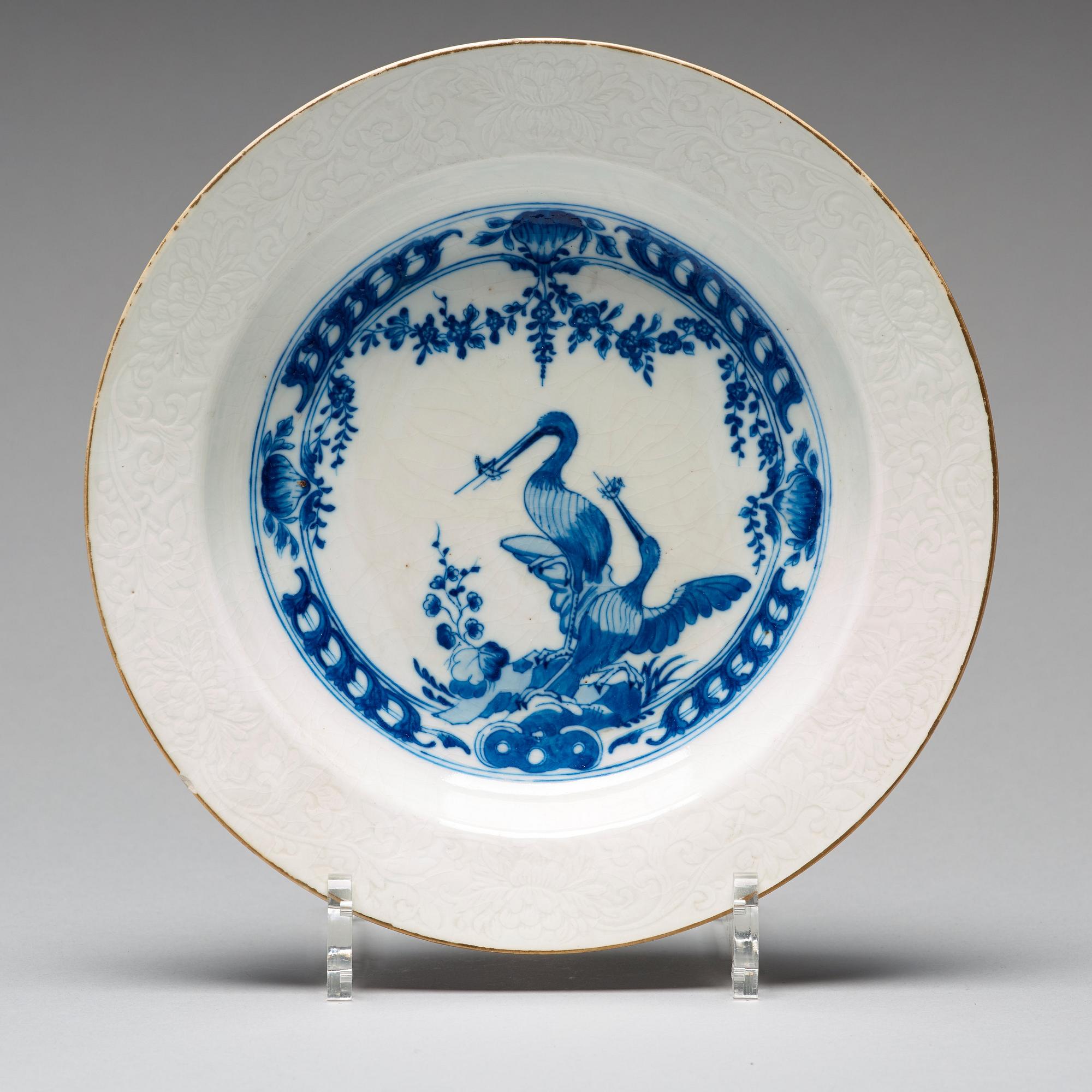 A set of eight blue and white armorial soup dishes, Qing dynasty, 18th Century.