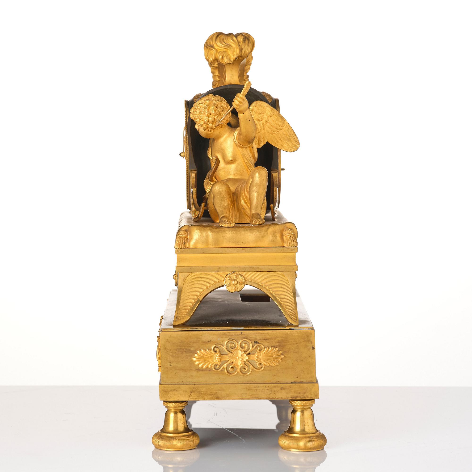 A French Empire sculptural ormolu and patinated bronze mantel clock, early 19th century.