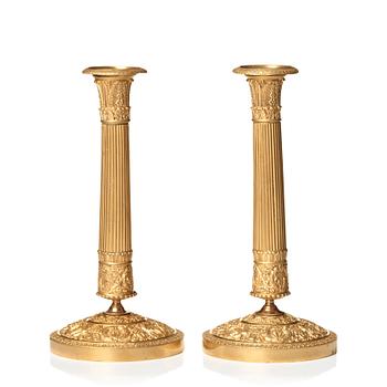 126. A pair of Empire candlesticks.