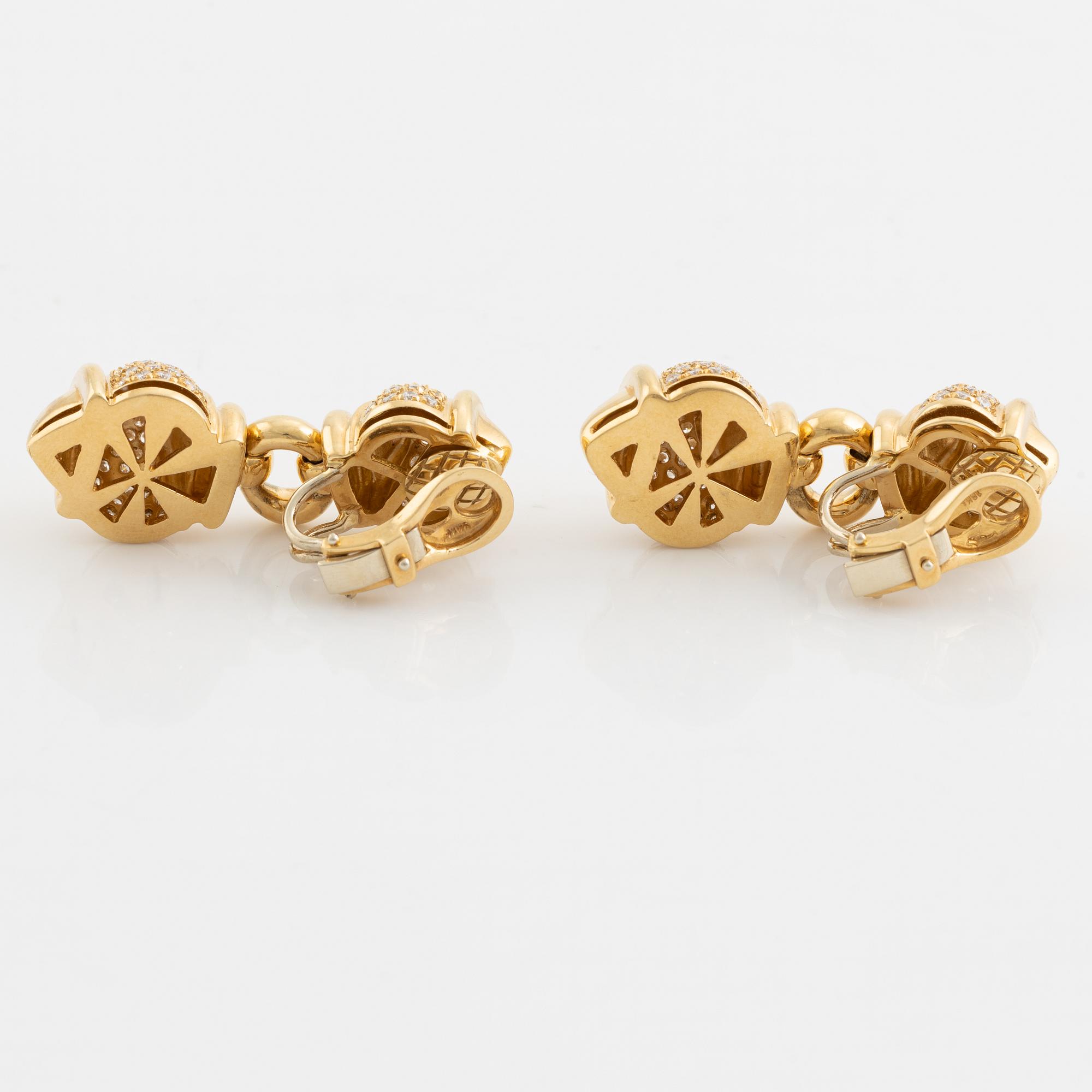 A pair of 18K gold earrings set with round brilliant-cut diamonds.