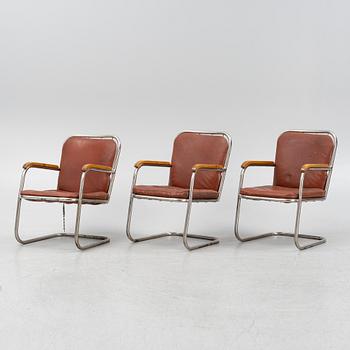 Three tubular steel armchairs, mid 20th Century.