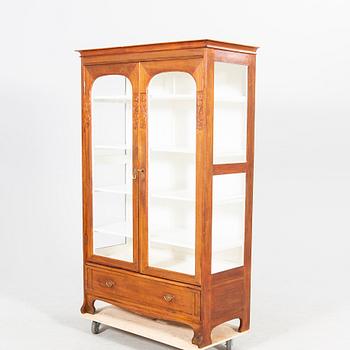 An early 1900s oak display cabinet.