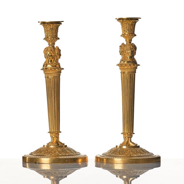 A pair of French Empire early 19th century gilt bronze candlesticks.