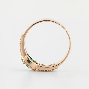 A faceted emerald and brilliant cut diamond ring.