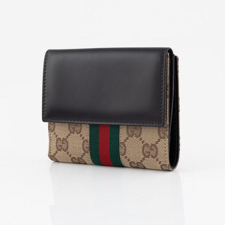 Gucci, a leather and canvas wallet, 1999.