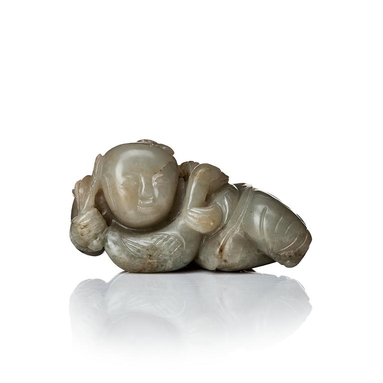 A neprite sculpture of a reclining boy with a duck, late Qing dynasty.