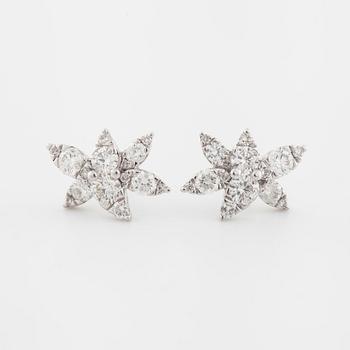 A pair of brilliant cut diamond earrings.