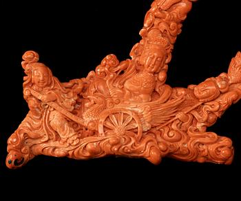 A carved coral of Xi Wang Mu in a Phoenix wagon among clouds and immortal maidens, China, presumably early 20th Century.