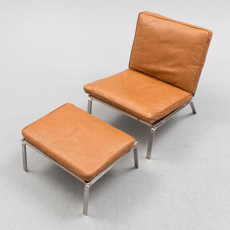 A 21st century easy chair and foot stool by Norr 11, Denmark.