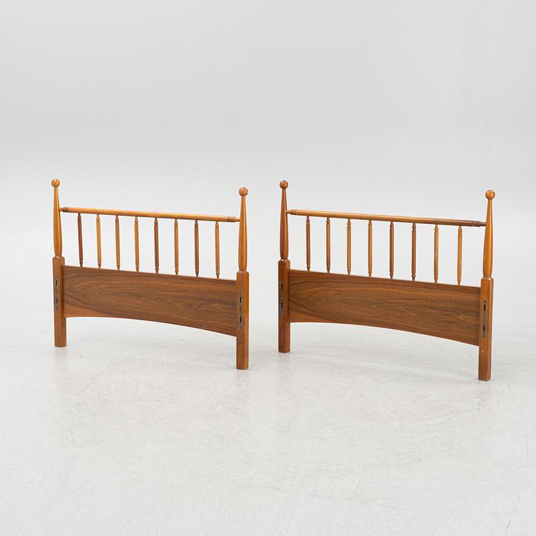 A pair of head-and foot boards to two beds, mid 20th century.
