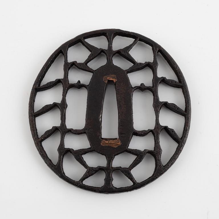 An iron open work, sukashi, Japanese tsuba, Edo (1603-1868). In a kiri box.