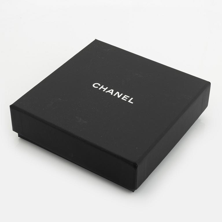 Chanel, a silver tone and leather bracelet.