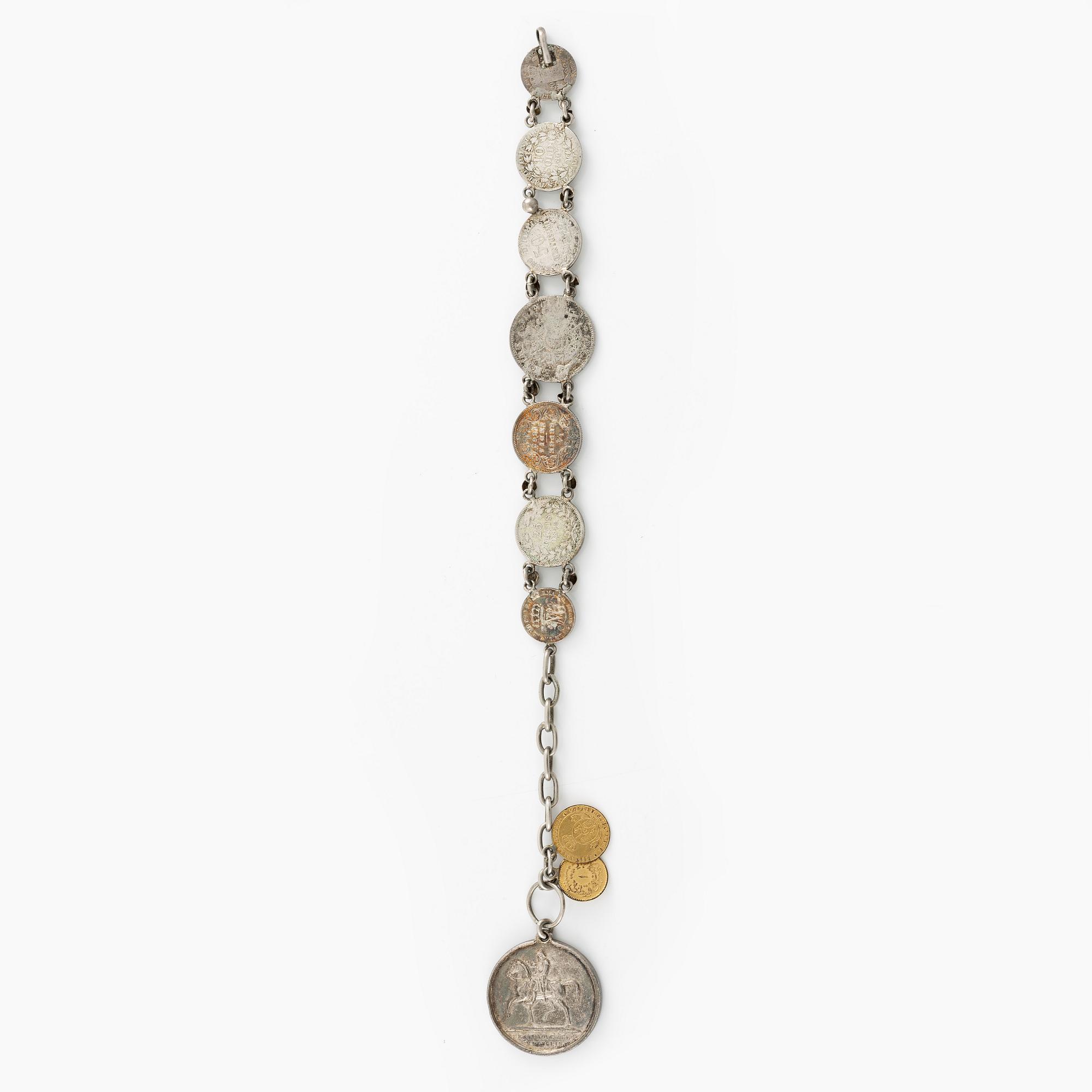 Two bracelets, a brooch, and a pendant with coins.
