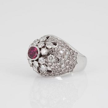 A RING set with an oval mixed-cut ruby and round brilliant- and eight-cut diamonds.