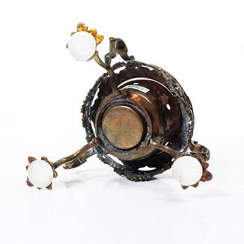 A German Rococo repoussé copper teapot on rechaud, mid 18th century.