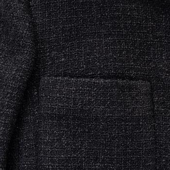Chanel, A black bouclé jacket, size 34.