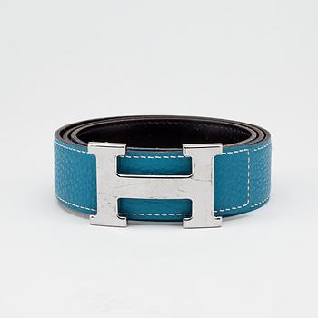 HERMÈS, a reversible belt, blue and brown with silver colored H belt buckle.