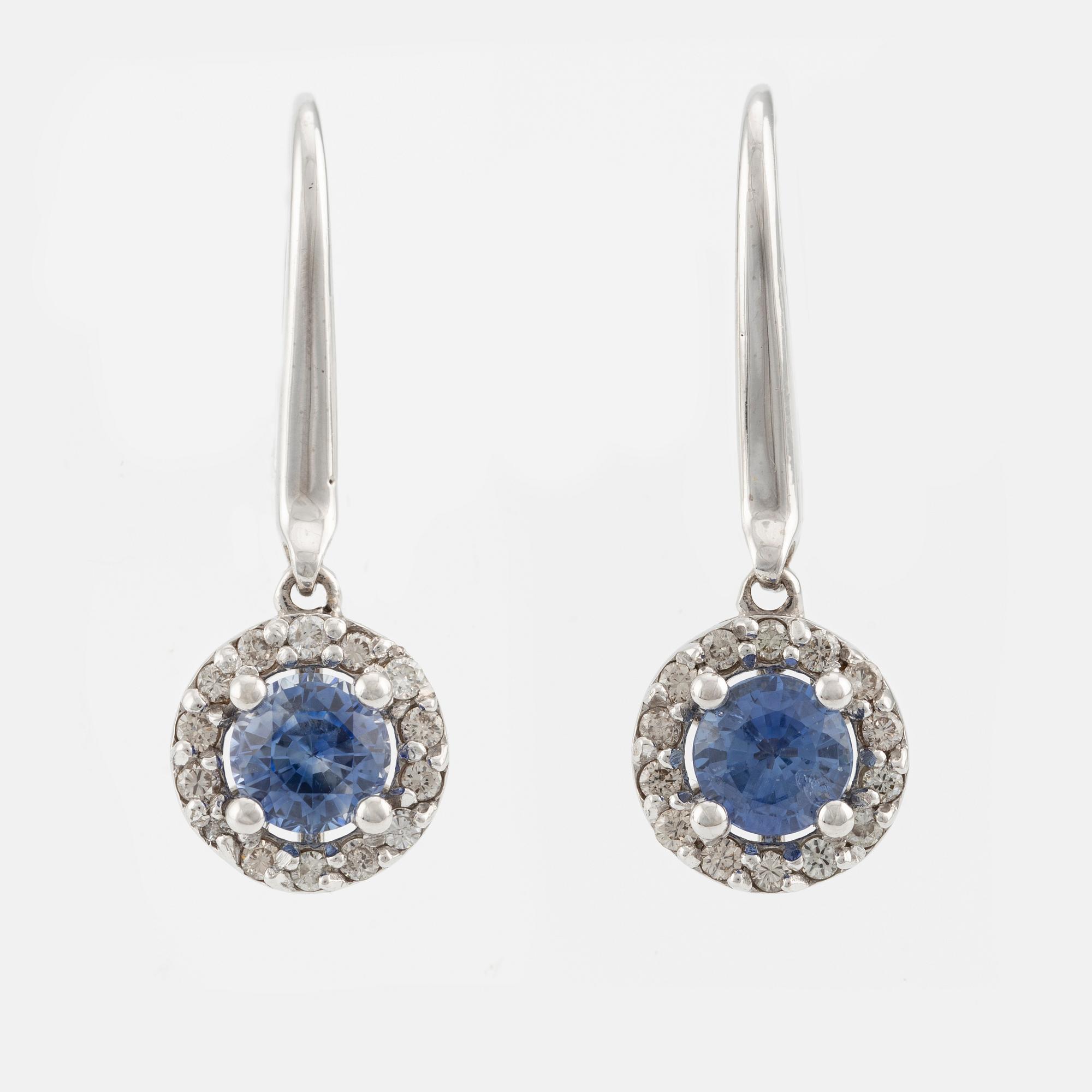 A pair of 18K gold earrings with faceted sapphires and round brilliant-cut diamonds.