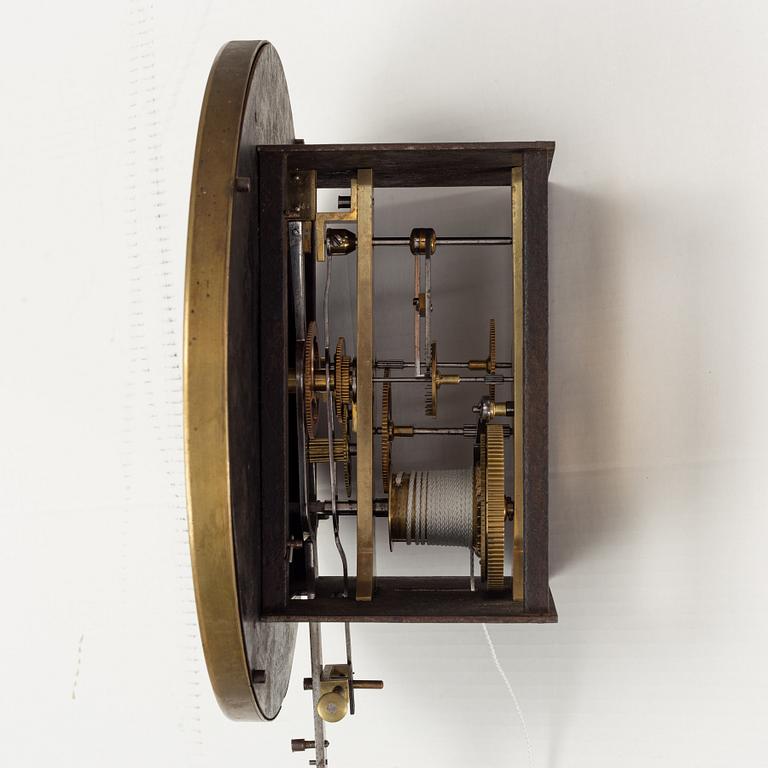A walnut long case clock, from around the year 1900.