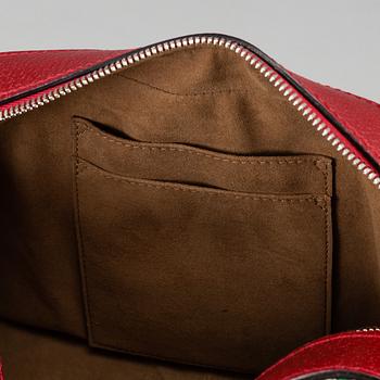 GUCCI, a patterned monogram canvas and leather bag.