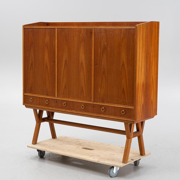 A teak-veneered mid 20th century sideboard.